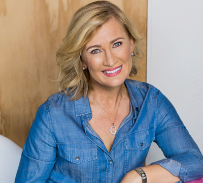 Head and shoulders photograph of Kim McCosker wearing a chambray blue shirt